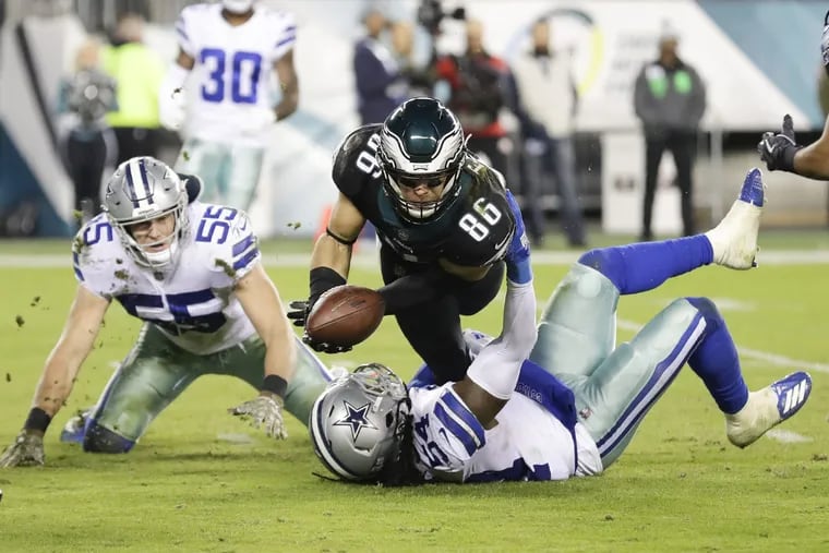 On the final play of the game, Zach Ertz tries to pitch the ball to Golden Tate as Cowboys linebacker Jaylon Smith takes him down.
