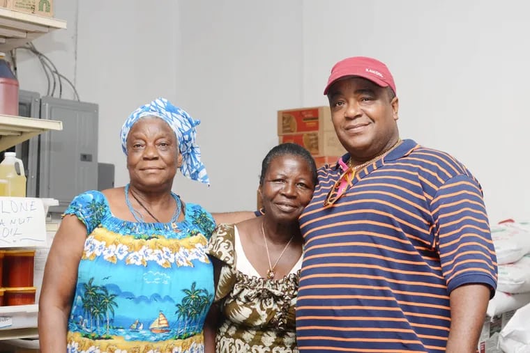 Alphonso Seke-Horton, owner of the Liberian Waterside Market, with his aunt Bindu, center, and his mother Pahn, left. His store is located at 6634 Woodland Avenue in Southwest Philadelphia.