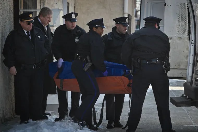 Philadelphia police carry the body of a mid 20's male from the scene of a homicide at Coin Laundromat 53rd and Springfield in southwest Philadelphia on Thursday morning, Feb. 19, 2015. (Alejandro A.
Alvarez / Staff Photographer)