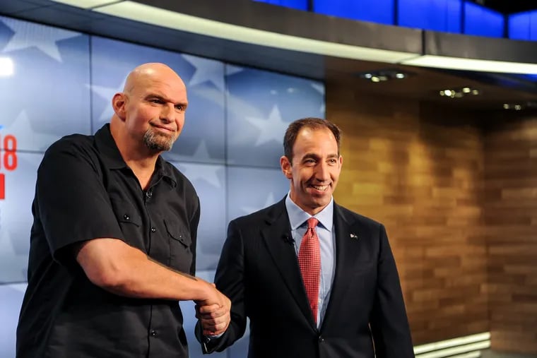 Candidates for lieutenant governor John Fetterman, left, and Jeff Bartos shake hands and pose for a photo before a televised debate Saturday at WPXI-TV in Pittsburgh.