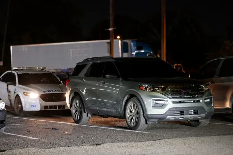 Shortly before midnight, Philadelphia police guard a Ford Explorer SUV Wednesday night that was found in the parking lot of the Dream Boutique Adult Entertainment Center on Passyunk Avenue. The Ford is believed to have been used in the shooting at Roxborough High School on Tuesday. Police on the scene said they were awaiting a police tow truck.