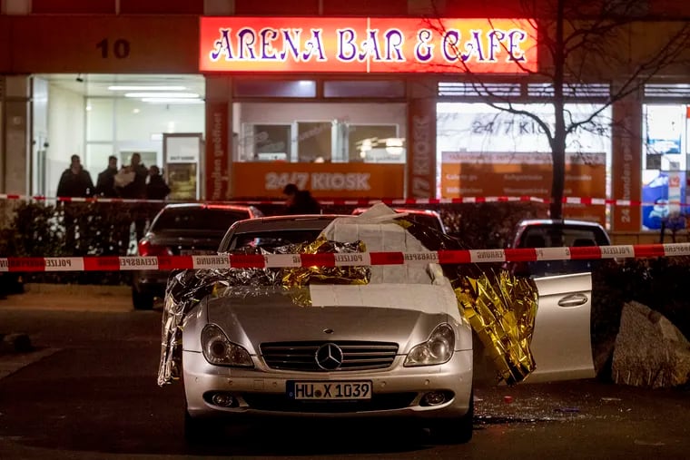 A car with dead bodies stands in front of a bar in Hanau, Germany, on Thursday.