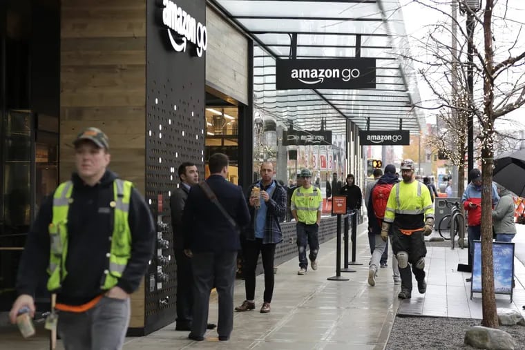 Construction workers mix with the noon lunch-hour crowd outside an Amazon Go store in downtown Seattle.