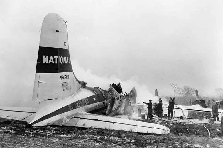Firefighters at the wreckage of National Airlines DC-14 when it slid off the runway and burst into flames at Philadelphia International Airport on January 14, 1951. Two infants and five women died, including heroic flight attendant Mary "Frankie" Housley.