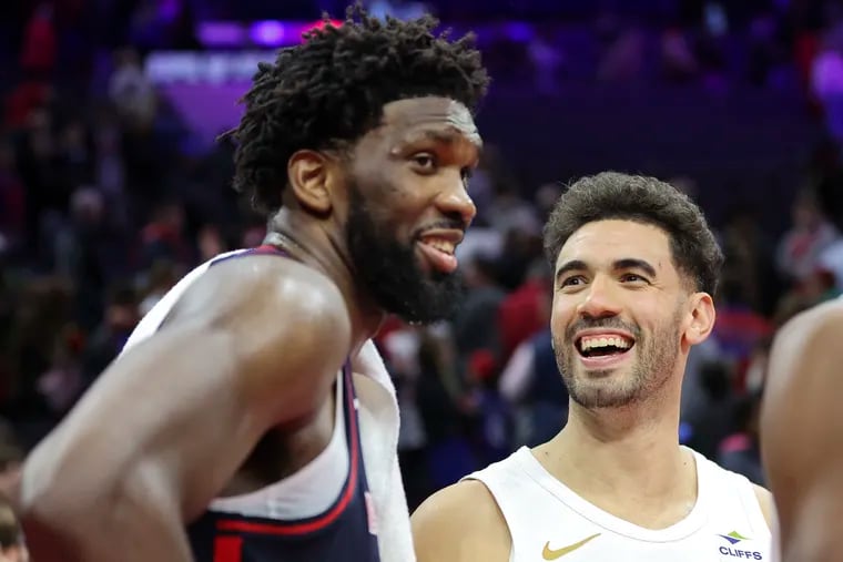 Cleveland Cavaliers forward Georges Niang, right shares a laugh with former teammate Joel Embiid during their game on Tuesday.
