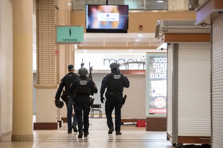 Police respond to a shooting at Newport Centre Mall in Jersey City, N.J., Friday, Jan. 11, 2019. (Reena Rose Sibayan/The Jersey Journal via AP)