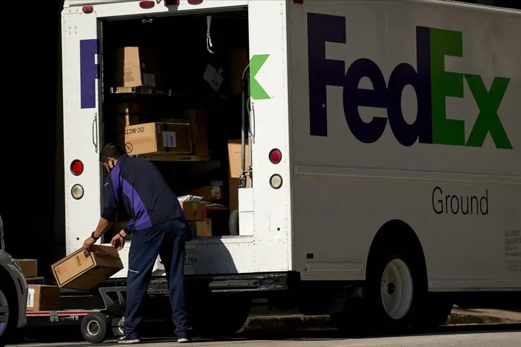 A FedEx Corp. worker wearing a protective mask unloads a truck in downtown Dallas in May.
