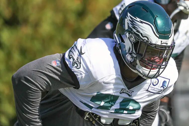 Eagles defensive tackle Albert Huggins stretches during his first day of practice at the NovaCare Complex on Wednesday.