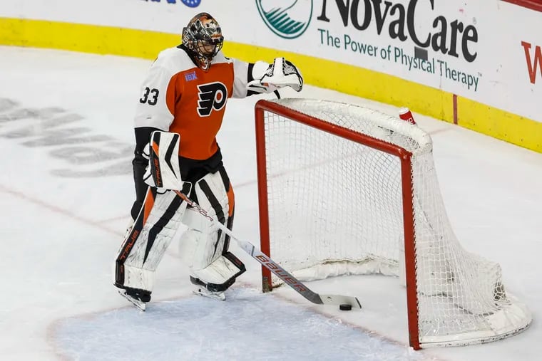 Flyers goalie Samuel Ersson takes the puck from the goal after Capitals star Alexander Ovechkin's opening goal.