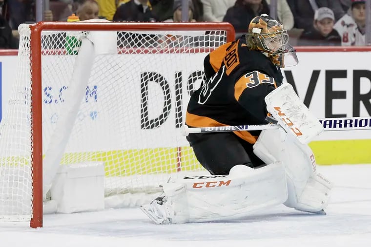 Flyers goalie Cam Talbot makes a stick save against the visiting Washington Capitals last season.