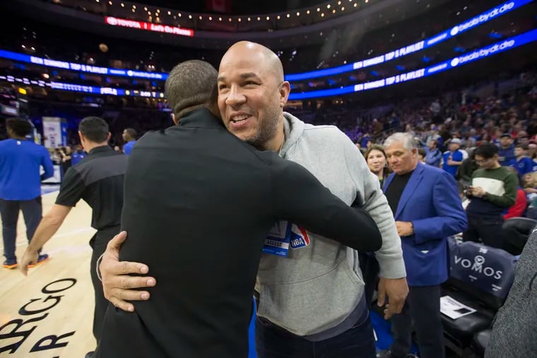 Former Temple great and NBA player Rick Brunson greets one of the officials before a 76ers' game in Philadelphia in January. He was there to watch his son Jalen play for the Dallas Mavericks. Rick Brunson on Tuesday was approved by Camden's board of education to become the basketball coach at Camden High.