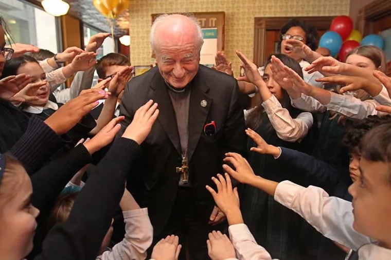 Archbishop Vincenzo Paglia, President of the Pontifical Council for the Family, is surrounded by the children of St. Peter the Apostle School as they raise their hands and say a blessing over him after the press conference for picking an official papal milskshake on Mar. 9, 2015. (Michael Bryant / Staff Photographer)