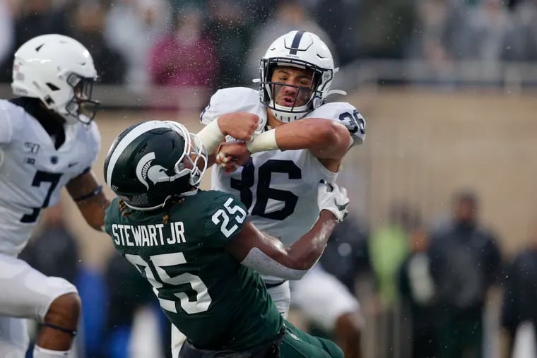 Penn State's Jan Johnson, right, hits Michigan State's Darrell Stewart (25) in the end zone on an attempted pass reception.