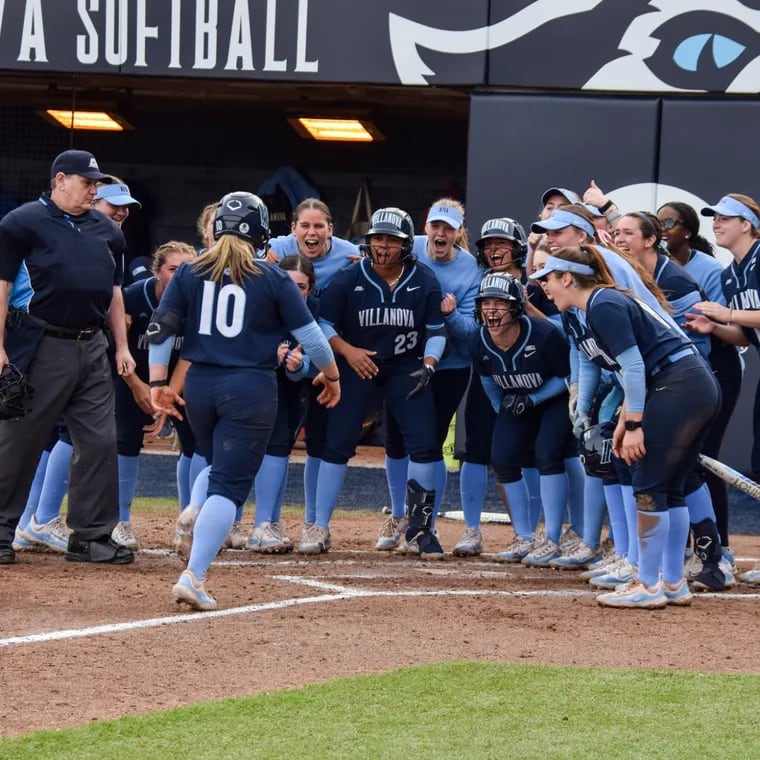 Shortstop Ava Franz receives a team welcome at the plate as she scores a run for the Villanova Wildcats.