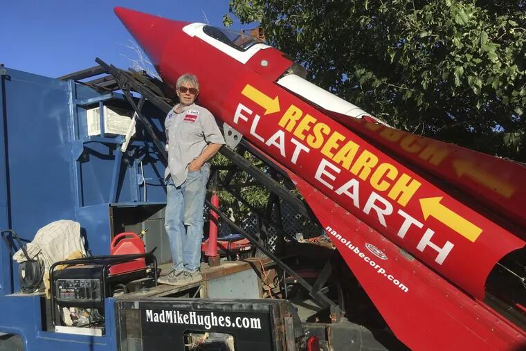 In this Wednesday, Nov. 15, 2017, photograph, daredevil/limousine driver Mad Mike Hughes is shown with with his steam=powered rocket constructed out of salvage parts on a five-acre property that he leases in Apple Valley, Calif.
