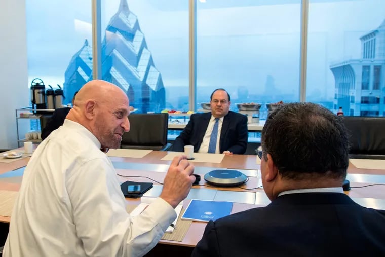 Thomas Henry Massaro (left), organizer of the class, engages Comcast's David Cohen while City Council member Allan Domb listens during a session in a 45th-floor conference room at the Comcast building.