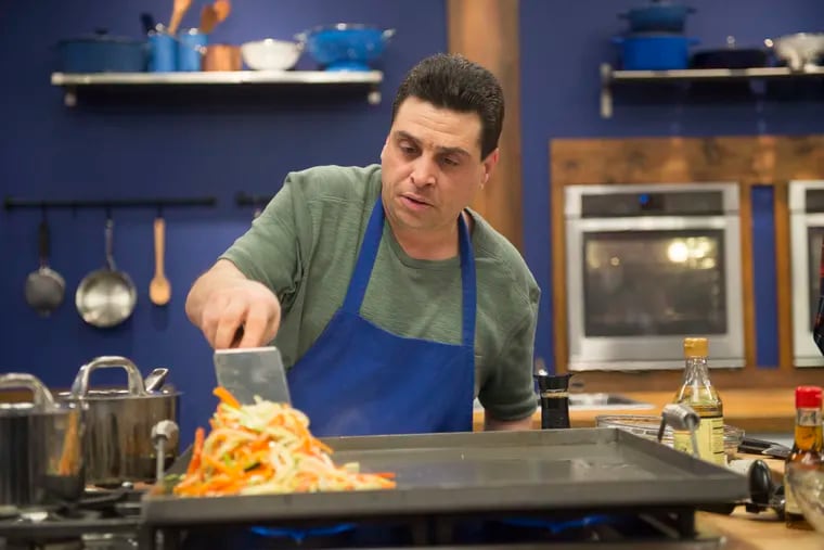 Contender Frank Scuderi races to finish his shrimp stir fry with rice dish, as seen on Worst Cooks In America, Season 14.