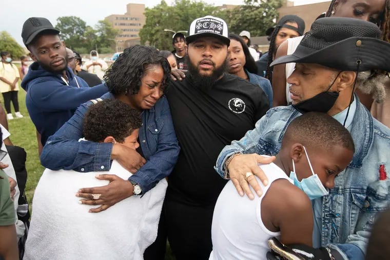 Girard College hosted a balloon release on June 7, 2022 for Kristopher Minners, 22, a school counselor for 6th and 2nd grade boys and one of the victims fatally shot in the South Street shooting on June 4, 2022. Family members, L-R: Darlena Selby (aunt), Marcus Dukes (cousin), and Minister Dukes-El, Kristopher's (uncle) comfort some of his students.