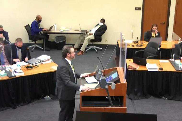 In this image taken from video, defense attorney Eric Nelson questions witness Los Angeles police department Sergeant Jody Stiger, as Hennepin County Judge Peter Cahill presides Wednesday, April 7, 2021, in the trial of former Minneapolis police Officer Derek Chauvin at the Hennepin County Courthouse in Minneapolis. Chauvin is charged in the May 25, 2020 death of George Floyd. (Court TV via AP, Pool)