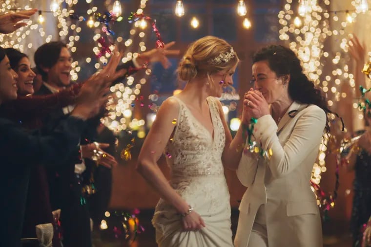This image made from undated video provided by Zola shows a scene of its advertisement. The Hallmark Channel says it will reinstate same-sex marriage commercials that it had pulled from the network. Hallmark Cards CEO Mike Perry said in a statement Sunday, Dec. 15, 2019, that pulling the commercials “was the wrong decision."