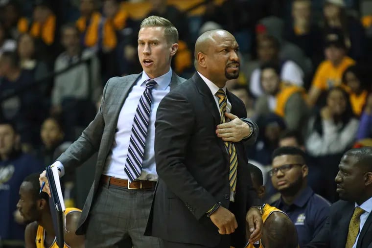 Kyle Griffin, shown here restraining La Salle head coach Ashley Howard after a technical foul call in a January 2019 game, has been promoted to associate head coach by Howard.