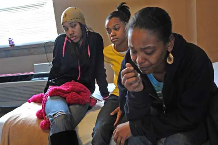 After a house fire at their apartment at 630 Perth Place in Northern Liberties, Kimberly Hollingsworth and her daughters, Ameerah White, 15. left; and Kiara White, 12, center; are staying at the Red Cross shelter in West Philadelphia on Dec. 22, 2012.  APRIL SAUL / Staff Photographer