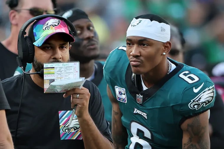 Eagles wide receiver DeVonta Smith (right) looks towards defensive coordinator Sean Desai (left) calls in a play late in the fourth quarter.