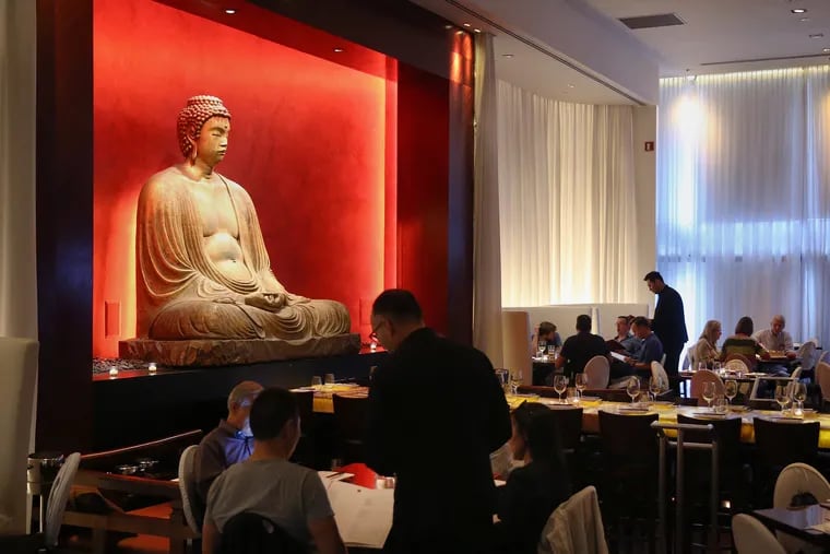 The dining room at Buddakan, watched over by  a giant golden Buddha.