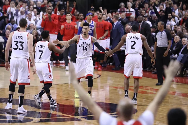 After a 3-pointer by Danny Green, center, Raptor fans and players celebrate during the 2nd half of their NBA Eastern Conference semifinal game at the Scotiabank Arena in Toronto on May 7, 2019.