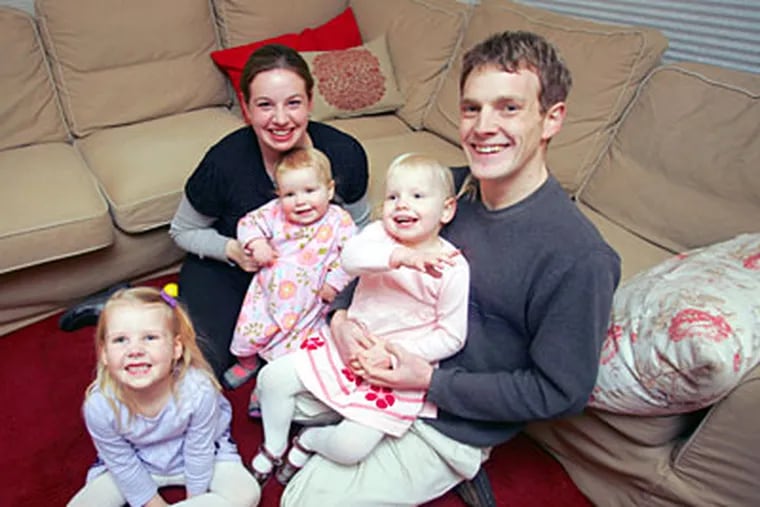 Jodi and Trevor Young and their daughters (in blue) Philippa Violet,
4, Romilly Alice, 3, and Beatrix Joanna, 18 months. ( David Swanson /
Staff Photographer )