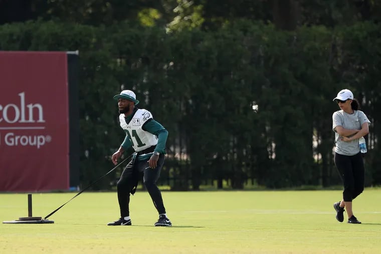 Eagles’ Jalen Mills works with Shireen Mansoori, director of rehabilitation, during Eagles training camp in Philadelphia, PA on July 31, 2019.