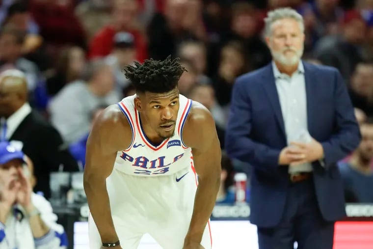 Sixers guard Jimmy Butler against the Toronto Raptors with head coach Brett Brown in the background on Saturday, December 22, 2018 in Philadelphia.
