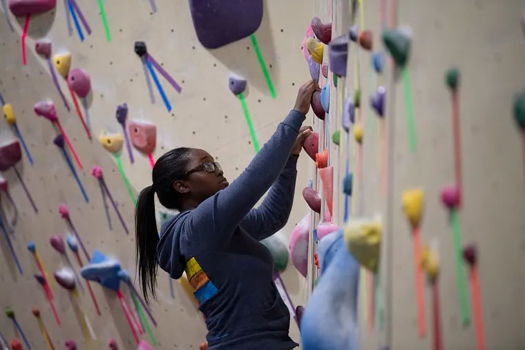 Zoe Little climbs a rock wall during a Brothers for Climbing session at the Philadelphia Rock Gym in Wyncote. The group meets the third Monday of every month.