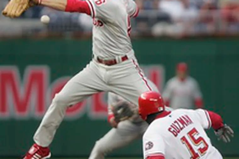 The Nationals&#0039; Cristian Guzman beats the throw to Phillies second baseman Chase Utley for a stolen base in the first inning of last night&#0039;s game in Washington.