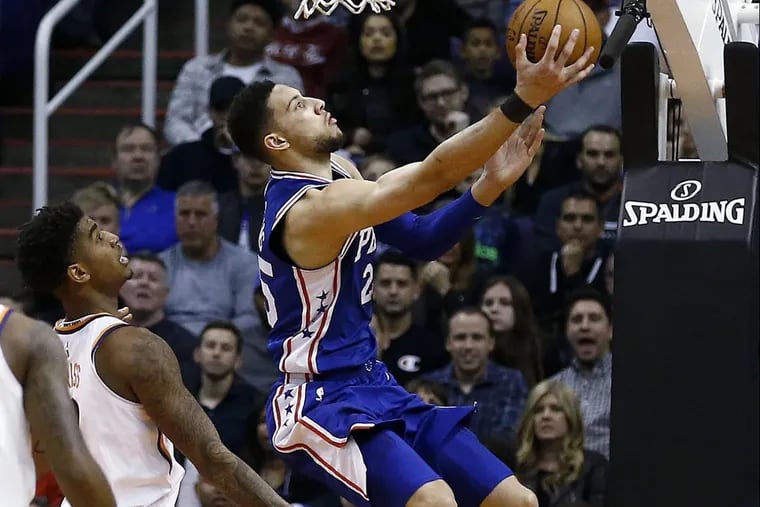 Sixers’ guard Ben Simmons, right, shoots as he gets past Phoenix Suns forward Marquese Chriss, left, during the team’s win over Phoenix on Sunday.