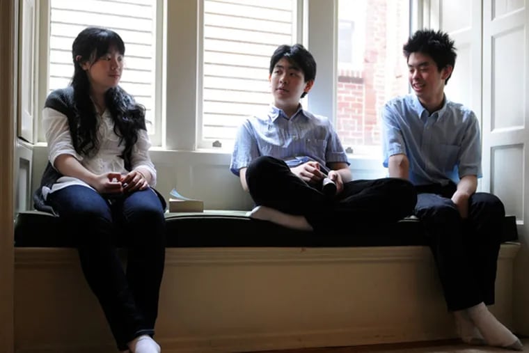 The Hsu family, all piano students at Curtis, in their Center City home. From left are Ashley, Daniel and Andrew.