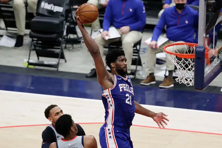 Sixers center Joel Embiid rises for a dunk past Washington Wizards forward Rui Hachimura and center Daniel Gafford in the second quarter of Game 3 of their first-round playoff series in Washington D.C., on Saturday, May 29, 2021.