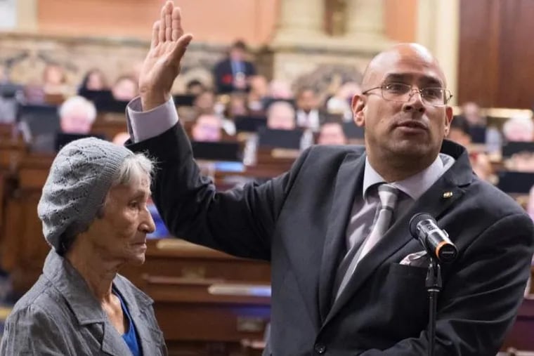 Emilio Vazquez is sworn in April 5 in Harrsiburg as the state representative for the 197th District of the state House as his mother, Bernarda Santiago, holds the Bible.