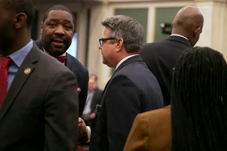City Councilmember Kenyatta Johnson briefly greets Councilmember Bobby Henon at his first Council meeting following his indictment on Thursday, Jan. 30, 2020. Both Henon and Johnson are being federally indicted.