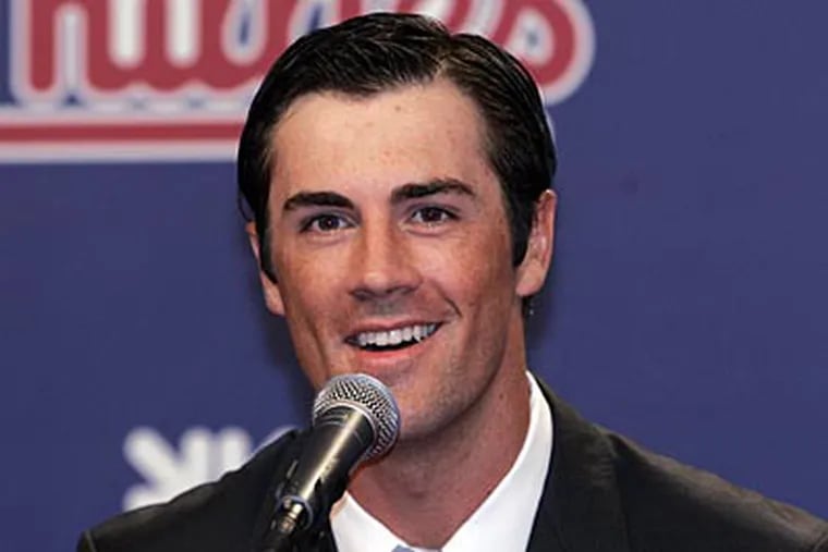 Cole Hamels signed a six-year, $144 million extension with the Phillies on Wednesday. (Tom Mihalek/AP)