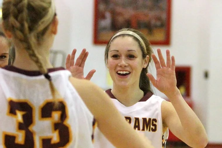 Becky Pund, right, of Gloucester Catholic high-fives teammate Michelle McCarthy as the starting line-up is introduced against West Deptford on Dec. 26, 2013.   ( CHARLES FOX / Staff Photographer )
