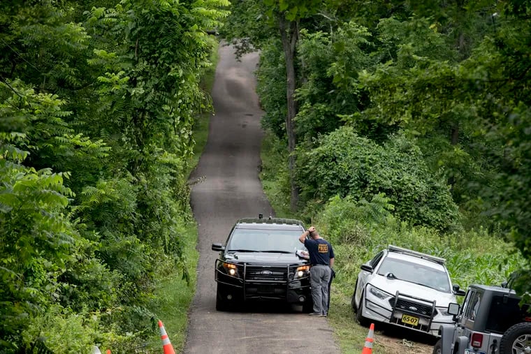 Police guard the driveway to the DiNardo family's farm in Solebury Township during the investigation into four murders there in 2017. Sean Kratz, one of the suspects in the case, confessed to killing one of the victims in a taped confession.