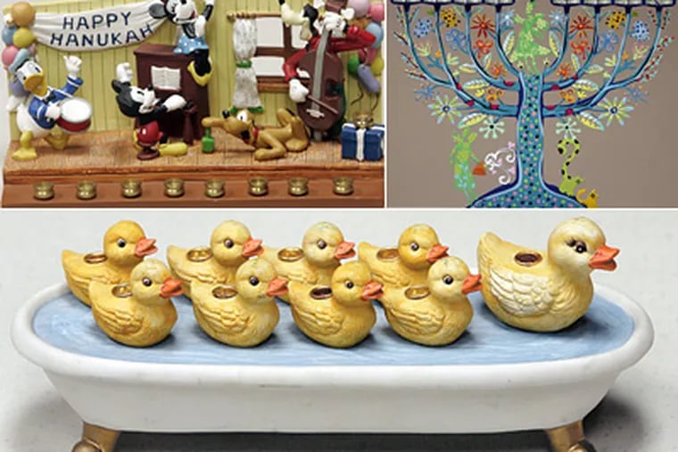 Clockwise from top left: A Disney menorah, a hand-painted tree, and ducks in a bathtub menorahs, all show how ritual objects changed to reflect Jewish life, hobbies and habits in America. (Bonnie Weller / Staff Photographer)