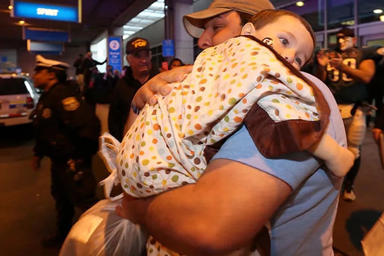 Young cancer victim Brayden Chandler with his Father Jason Chandler at the Philadelphia International Airport after returning home from Disney World in Orlando, FL on Tuesday, February 18, 2014.  ( Yong Kim / Staff Photographer )
