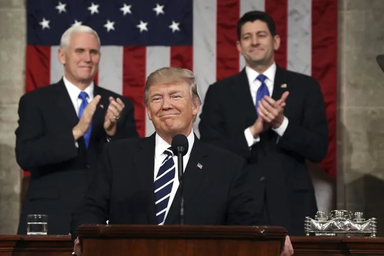 Vice President Mike Pence (L) and Speaker of the House Paul Ryan (R) applaud as US President Donald J. Trump (C) arrives to deliver his first address to a joint session of Congress from the floor of the House of Representatives in 2017. Traditionally, the first address to a joint session of Congress by a newly-elected president is not referred to as a State of the Union.