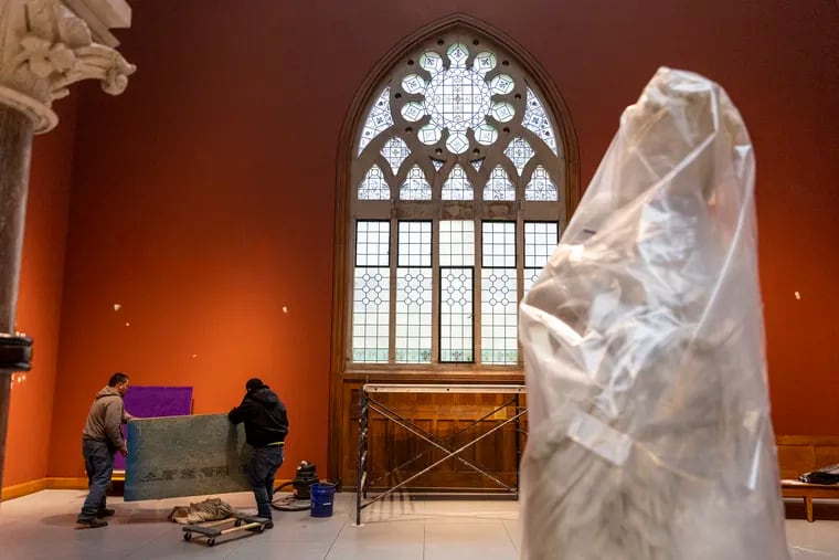Workers prepare for installing "Rising Sun: Artists in an Uncertain America" in the Pennsylvania Academy of the Fine Arts 1876 building. The sculpture with protective wrapping is "Hypathia" by  Howard Roberts. It is one of the few older works that will stay in the building when "Rising Sun" opens in March.