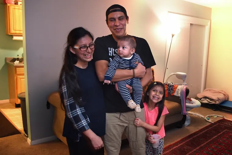 Emerson Hernandez holds his five month-old son Aaron Hernandez upon returning home with his daughter Madyson Hernandez (right), and they're joined by mom Madelin Soto (left).