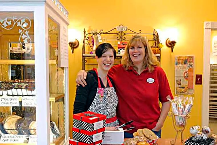 Victoria Malvey (right), co-owner of Victorian Savories Bakery and bakery manager Sarah Sickler (left) at the bakery in the Burlington Center on November 5, 2013.  ( ELIZABETH ROBERTSON / Staff Photographer )