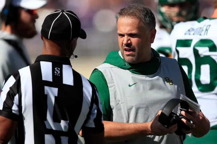 Baylor head coach Matt Rhule, right, talks with line judge Quentin Givens, left, during the first half of an NCAA college football game against Kansas State in Manhattan, Kan., Saturday, Oct. 5, 2019. (AP Photo/Orlin Wagner)