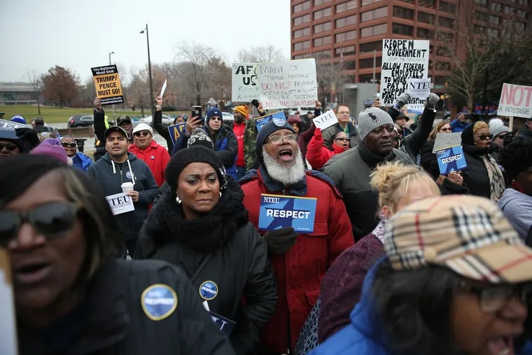 Federal workers cheer during a rally to protest the government shutdown in People's Plaza in Philadelphia on the morning of January 8, 2019.